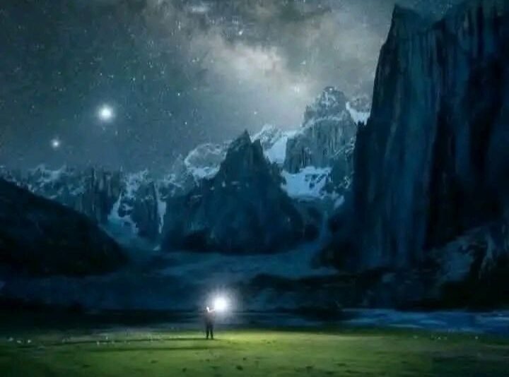 The granite walls of Nangma under a night sky, a single headlamp on the meadow